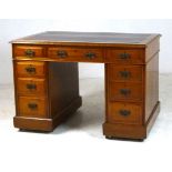 An early 20th century walnut twin pedest