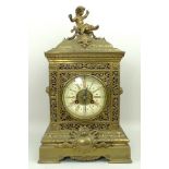 A Victorian brass mantel clock, the dial