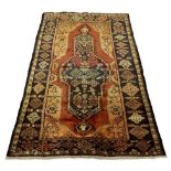 A Hamadan rug with dark blue, red and be