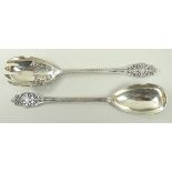 A pair of silver salad servers with pier