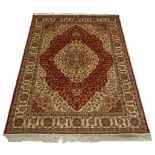 A Kum rug with red and beige ground, cen