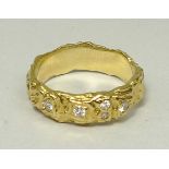 An 18ct gold and five stone diamond wedd