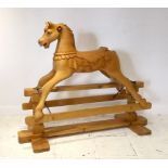 A pine rocking horse, carved with detail