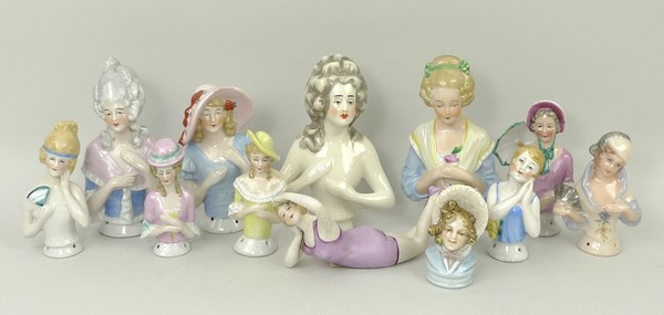A quantity of porcelain pin cushion doll