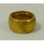 An antique gentleman's gold ring, tested as 22-24ct, of textured finish, size L, 30.3g.