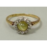 An 18ct gold, cat's eye and diamond ring, approximately 0.4ct, size N.