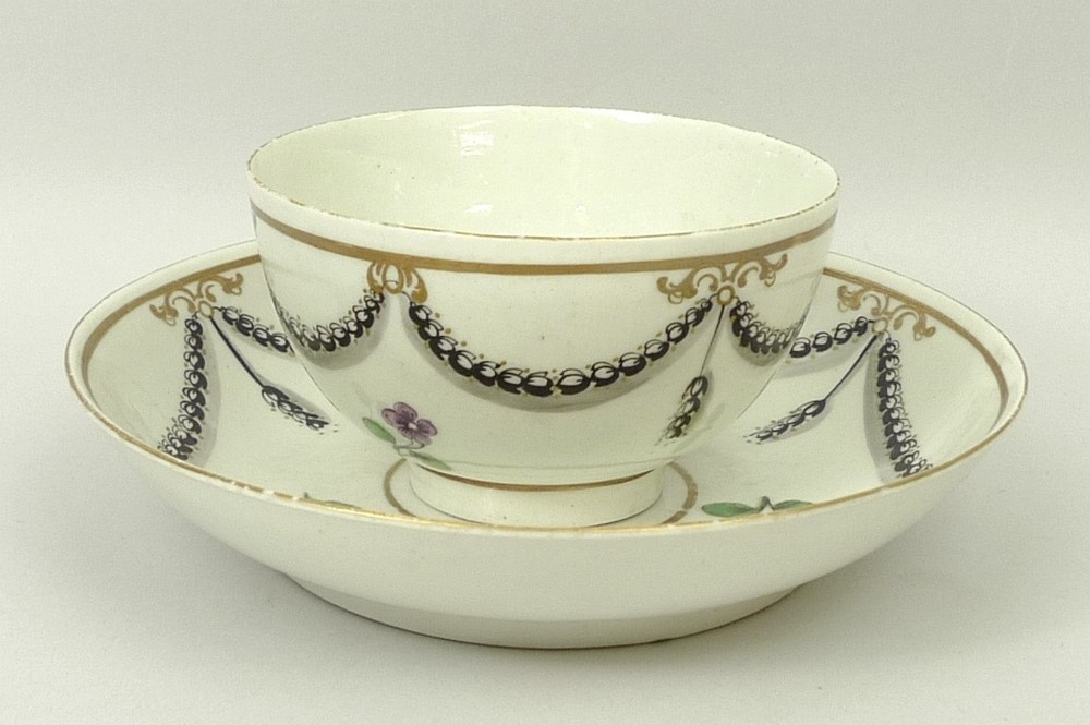 A Worcester, First Period, porcelain tea bowl and saucer, circa 1780, decorated with floral sprigs