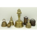 An Indian elephant claw brass bell, a brass bell with a handle in the form of an Indonesian figure,