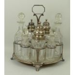 A George III/IV composite silver and cut glass six bottle cruet, the stand London 1805, bottles