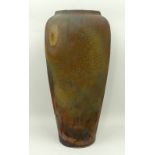 A Raku studio pottery vase of shouldered, tapering form with a textured iridescent lava glaze, JG