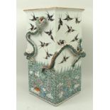 A Qing dynasty, 19th century, famille vert square vase decorated with a sea dragon, modelled in