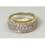 An 18ct white and yellow gold ring pave set with forty three brilliant cut diamonds, approximately