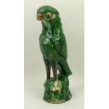 A Qing dynasty, 19th century, green glazed porcelain figure of a parrot, 20cm high.