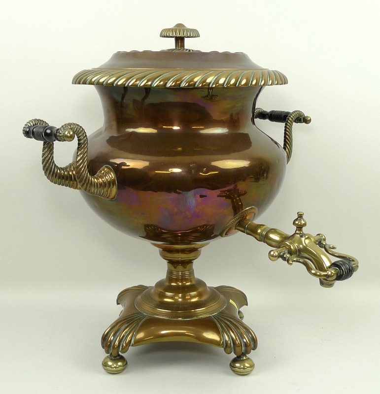A 19th century copper and brass samovar, raised on a footed base, 40cm.