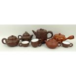 A group of 20th century Chinese Yixing pottery, comprising; five teapots, largest 12cm high, and