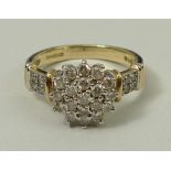 A 9ct gold and diamond dress ring of starburst form, the banded shoulders set with four diamonds