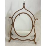 An Edwardian satinwood skeleton frame toilet mirror, with oval plate and turned finial, 52 by 24 by