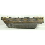A late 19th century oak carved ships hull, with gilt decoration, 85 by 23cm.
