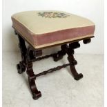 A 19th century mahogany X frame stool carved with C-scroll decoration, united by turned rails, with