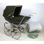 A Marmet pram with sun canopy, bag and shopping tray, in dark green livery, 122 by 57 by 121 high.