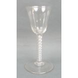 A George III wine glass, circa 1760, the funnel bowl above a double air twist stem, raised on a
