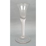 A George III wine glass, circa 1760, the bell shaped bowl above an air twist stem, raised on a