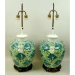 A pair of 20th century Chinese ceramic table lamps of triple handle vase form painted in shades of