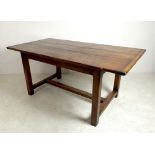 A fruitwood refectory kitchen table, three plank top with breadboard ends, on a trestle base, 168