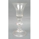 A George I wine glass, circa 1715, the bell shaped bowl above an angular knopped and double cushion