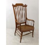 An Arts and Crafts bentwood armchair, marked to back of seat W. B, the spindle back and arms raised