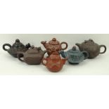 A group of six 20th century Chinese Yixing pottery teapots, three modelled as mythical creatures,