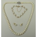 A cultured pearl single strand necklace on a white metal and old cut diamond set snap clasp, gold