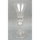 A George I wine glass, circa 1720-30, the bell shaped bowl with a solid base, above an inverted