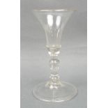 A George II wine glass, circa 1740, the flared bell shaped bowl above a teared balustroid stem,