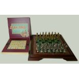 A cast metal chess set and board, and a Mah Jong set, boxed.