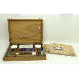 A French, late 19th century, artist's paint box containing two pairs of ceramic dishes and paints,