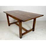 A fruitwood refectory kitchen table, three plank top with breadboard ends, on a trestle base, 168