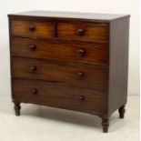 A George III mahogany and oak chest of two short over three long graduating drawers with cock
