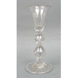 A George I gin glass, circa 1720/30, the trumpet shaped bowl above a double knopped and tear drop