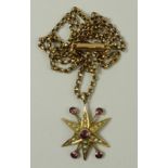 A garnet and seed pearl star burst pendant, the six pointed star set with seed pearls, with four