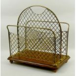 An early 20th century brass magazine rack with an oak base, raised on brass ball feet, 39 by 23 by