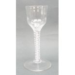 A George III wine glass, circa 1760, the ogee shaped bowl with moulded fluting, raised on a double