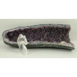 A purple amethyst gerde, 50 by 18 by 10cm, and a clear quartz model of a horse's head, 13cm.