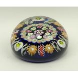 A Victorian concentric millefiori and twisted cane paperweight against a blue ground, 7.5cm