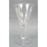 A George III wine glass, circa 1760, the funnel shaped bowl with faint moulded fluting, raised on