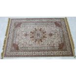 A small modern part silk rug, the central medallion on a cream and burgundy ground with densely