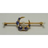 An Edwardian 15ct gold, Ceylon sapphire and diamond crescent bar brooch interspersed with three