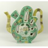 A Qing dynasty porcelain puzzle teapot, 19th century, decorated in famille verte with a wise man in