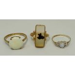 A 9ct gold and white opal set ring, size S, 9ct gold, opal and diamond ring, size L, and a 10ct