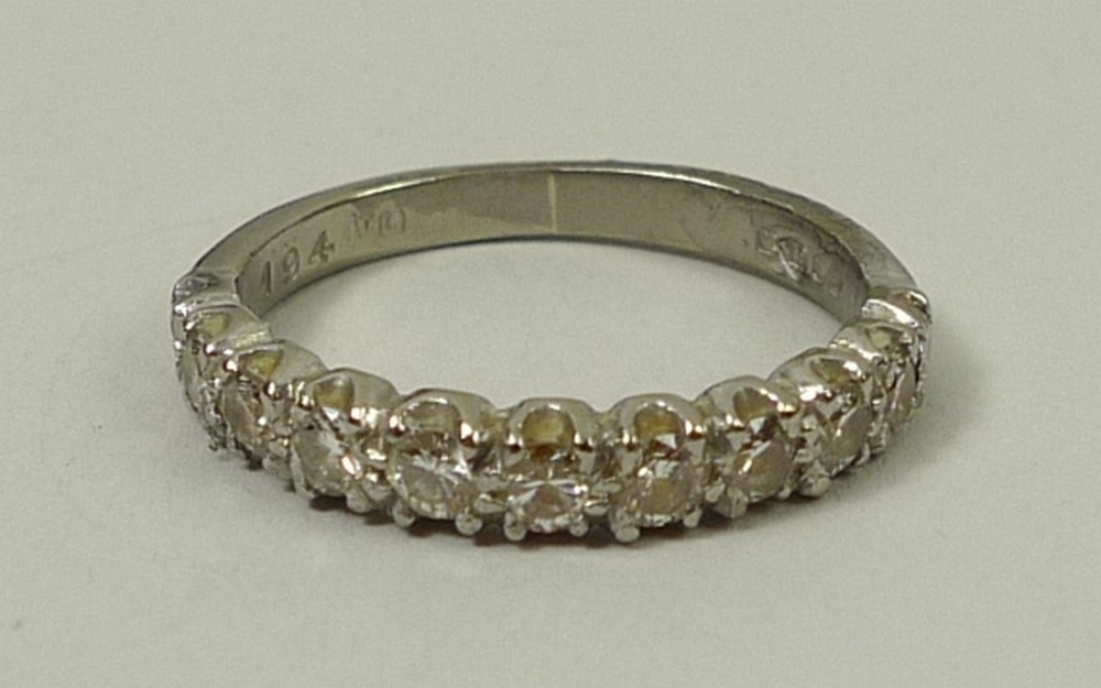 An 18ct white gold and diamond half hoop eternity ring, approximately 0.4ct, size I, 2.8g.